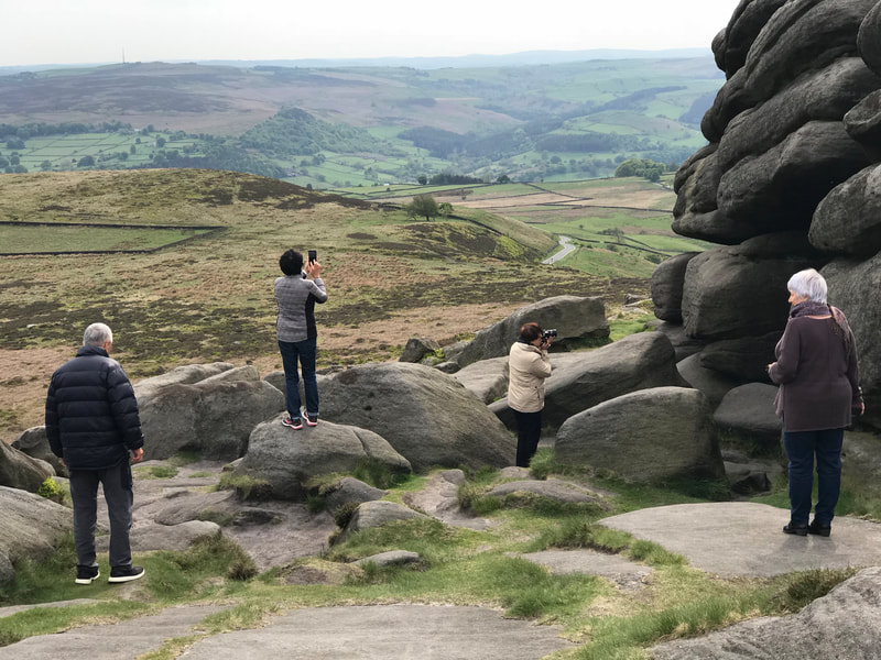 Taking photographs at Higger Tor on a Peak District scenic tour