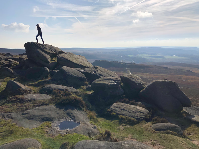 Climbing the rocks at Higger Tor in the Peak District