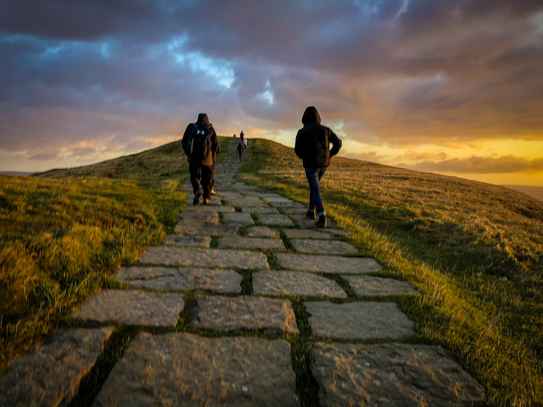 Walking up Mam Tor in the Peak District at sunrise