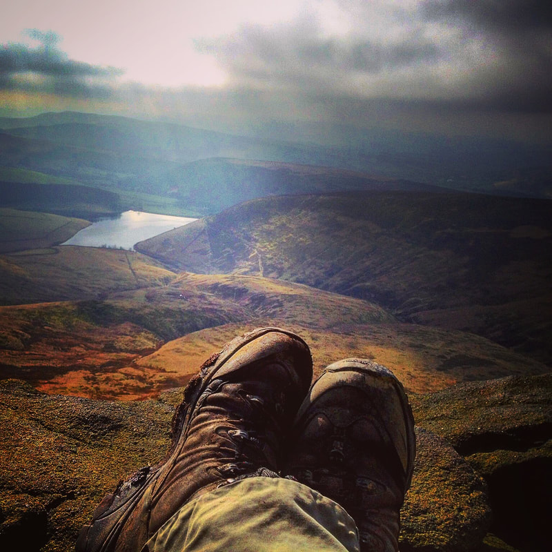 View from Kinder Scout over Hayfield, with walking boots