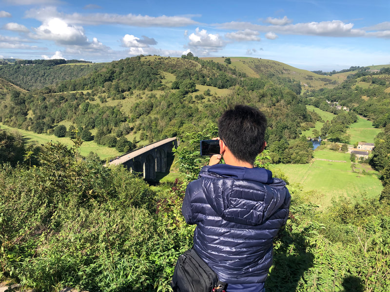 Tourist taking picture of Monsal Dale from Monsal Head