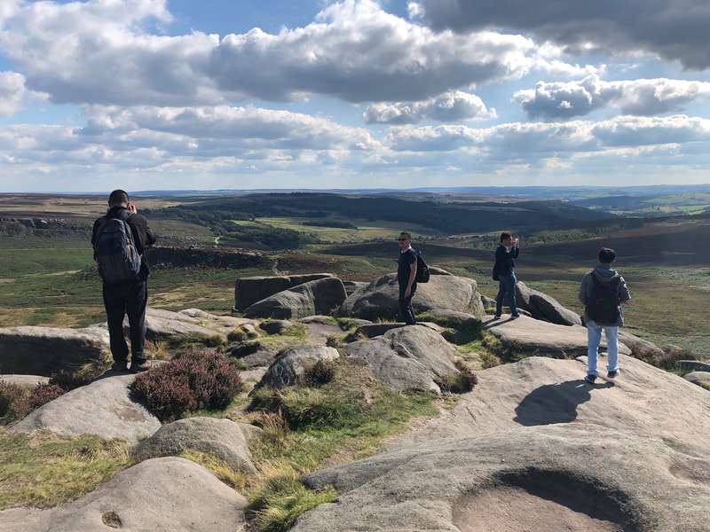A Peak District Tour group exploring Higger Tor